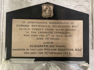 The memorial plaque for Edward 
and Elizabeth Wilkinson on the 
wall in the South Aisle of the 
Cathedral. Image: ULAS