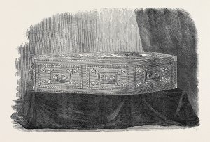 A Victorian coffin decorated with 
coffin studs, a nameplate, lid motifs, 
escutcheons on the sides, and 
decorative grips and grip plates. 
Many of our late 18th and 19th 
century burials have coffin furniture 
like this. Most coffins had a name 
plate, usually made of iron although 
we have had two examples in brass. 
More elaborate coffins were covered 
with a felt-like fabric fixed down with 
coffin studs or coffin 'lace' (bands of 
tin-dipped stamped iron in assorted 
decorative patterns, for outlining the 
lid, sides, and ends of a coffin). Some 
were augmented with other lid motifs.