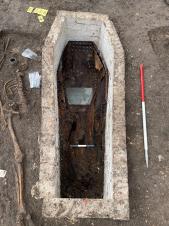 The brick-lined grave 
and wooden coffin of 
Anne Barratt. Her 
grave was dug through 
an earlier burial, a 
testament to how 
crowded the burial 
ground was in the 19th 
century. Image: ULAS